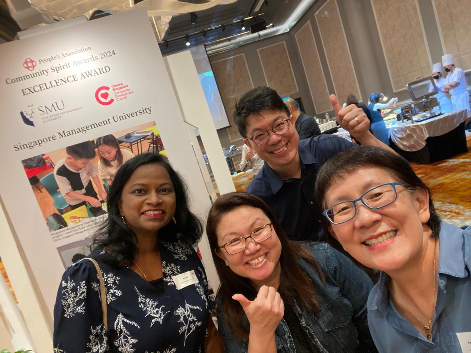 Ms Devi (first from left) and Professor Paulin Straughan (first from right) with Ms Lau Siew Ching, General Manager and Mr Cher Jin Zhi, Deputy General Manager, Central Singapore CDC.