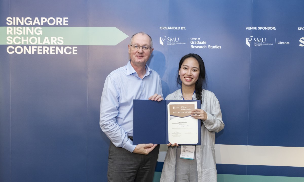 SMU Provost Prof Timothy Clark (left) with Ms Mengchen Zhen of Boston University who won the Best Paper on Marketing at the Singapore Scholars Conference 2024.
