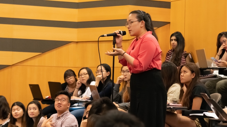 A member of the audience participating in the Q&A session.