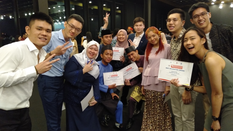 Team SMU with students from Brunei and Australia with their Best Delegation award.