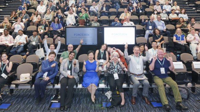 Conference speakers and participants gather for a group photo on day one of FORCE2026