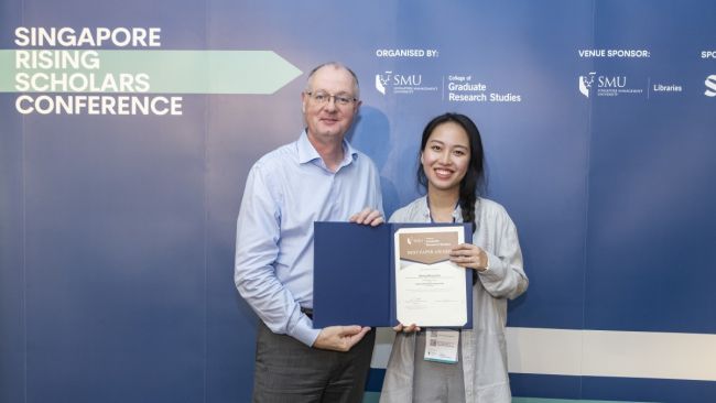 SMU Provost Prof Timothy Clark (left) with Ms Mengchen Zhen of Boston University who won the Best Paper on Marketing at the Singapore Scholars Conference 2024.