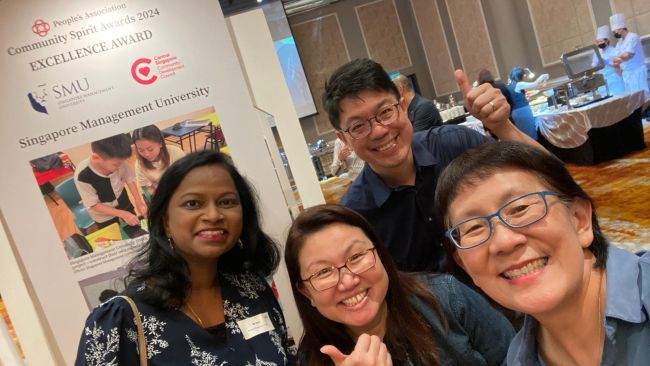 Ms Devi (first from left) and Professor Paulin Straughan (first from right) with Ms Lau Siew Ching, General Manager and Mr Cher Jin Zhi, Deputy General Manager, Central Singapore CDC.